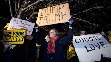 Protestors picket outside a hotel where Republican presidential candidate, Donald Trump will address a regional police union meeting in Portsmouth, N.H., Thursday, Dec. 10, 2015. (AP
