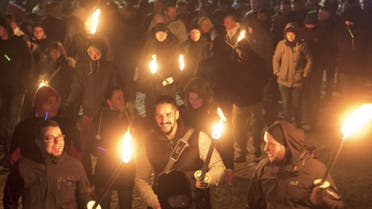 People demonstrate with torches during a rally against a refugee camp with immigrants and asylum-seekers initiated by NPD (National Democratic Party of Germany) in Schneeberg, eastern Germany, Saturday, Nov. 16, 2013. (AP)