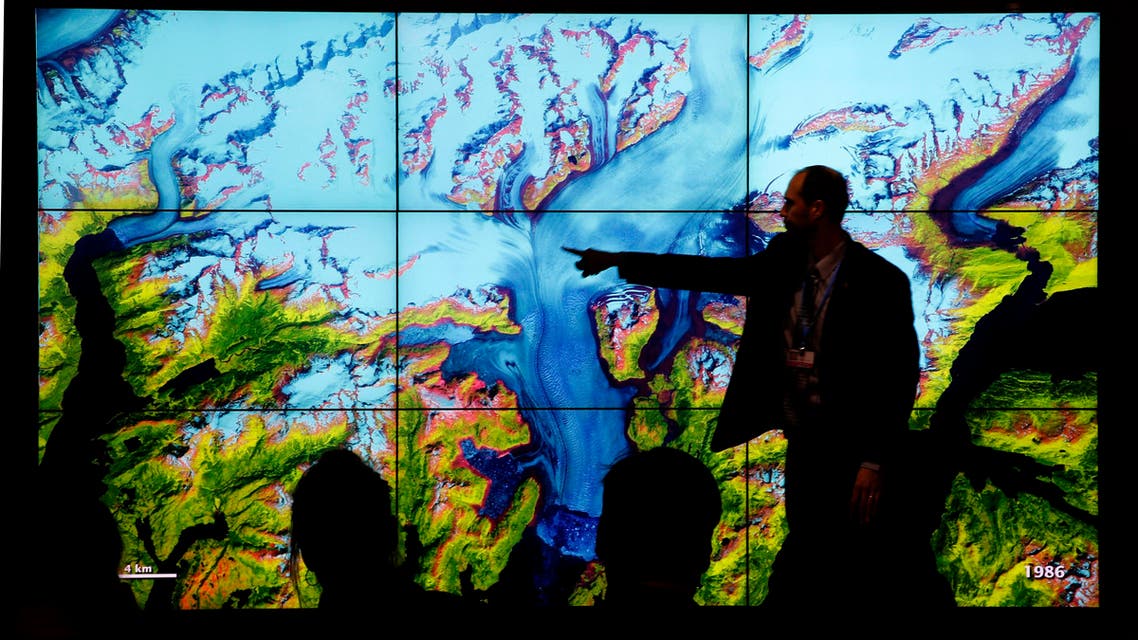 People attend a climate conference at the U.S. pavilion during the COP21, United Nations Climate Change Conference in Le Bourget, north of Paris, Thursday, Dec. 10, 2015.