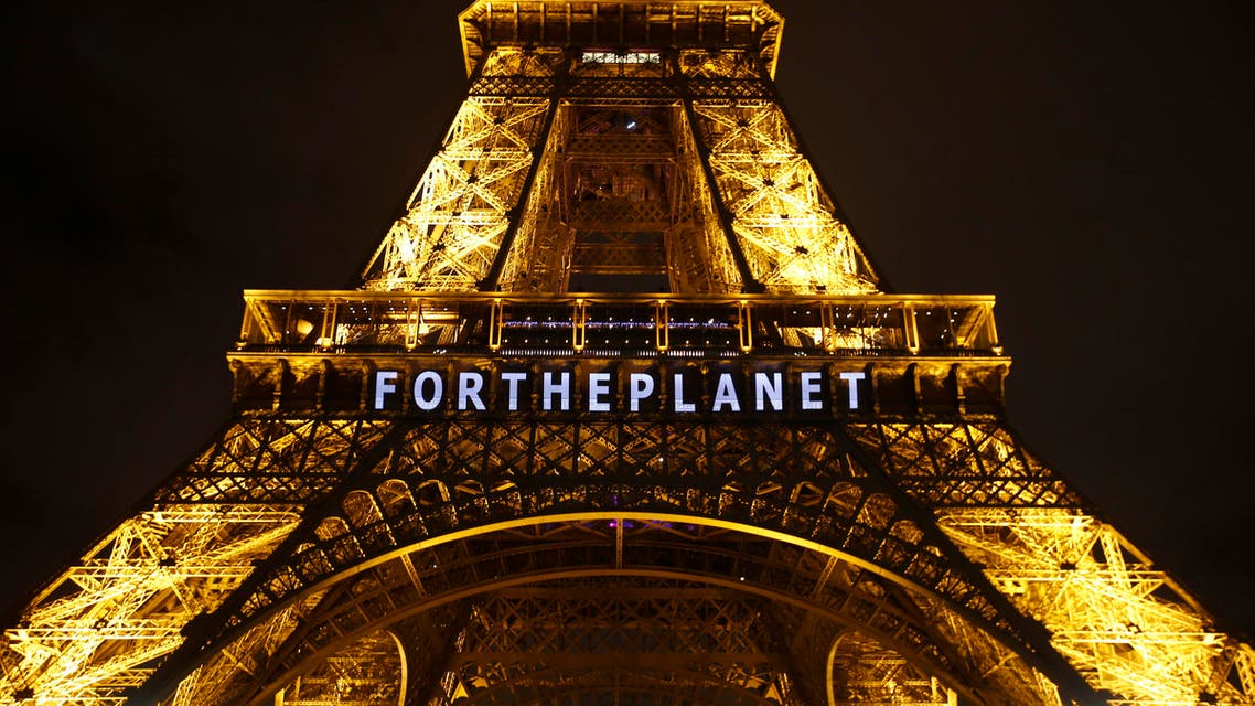 The slogan ‘FOR THE PLANET’ is projected on the Eiffel Tower as part of the COP21, United Nations Climate Change Conference in Paris, France, Friday, Dec. 11, 2015. (AP)