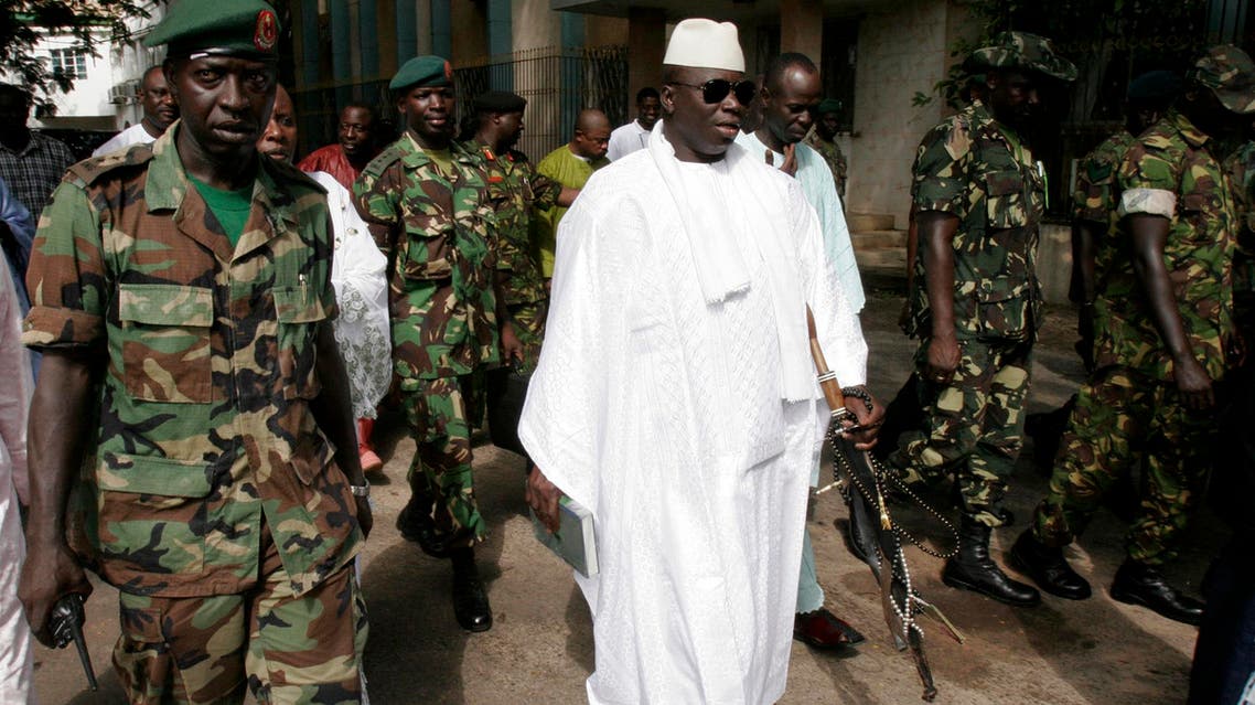 In this Friday, Sept. 22, 2006, file photo, Gambian President Yahya Jammeh, center, leaves a central Banjul polling station after casting his vote for president in Banjul, Gambia.