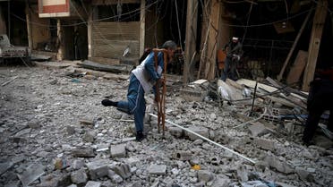 Men search for belongings at a site hit by missiles in the Douma neighborhood of Damascus, Syria December 13, 2015. Reuters)