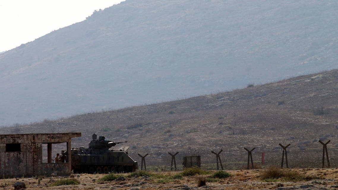 A Turkish soldier stands near an armored vehicle at the border with Syria near Cilvegozu, Turkey Tuesday, Sept. 3, 2013. AP