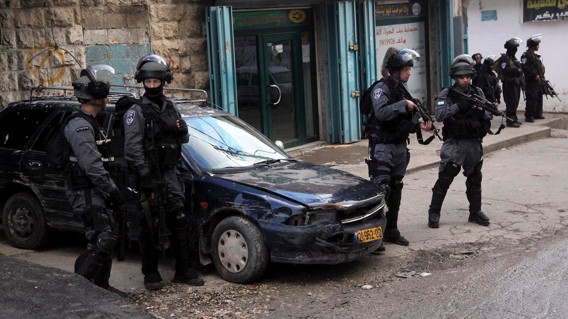 Israeli policemen stand guard in the Palestinian refugee camp Shuafat in Jerusalem. (AP)