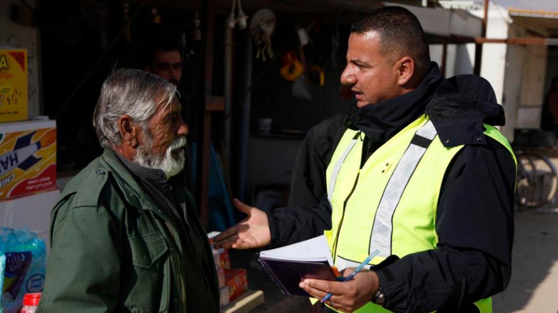 Mohanad Al Momani, a Jordan community police assistant, talks to a refugee on a patrol in Zaatari refugee camp, Jordan. (AP)