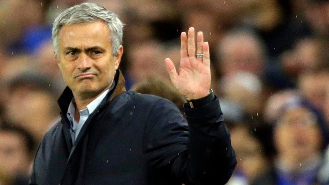 Chelsea manager Jose Mourinho waves to fans singing in his support during the Champions League Group G soccer match between Chelsea and Dynamo Kiev. (AP)