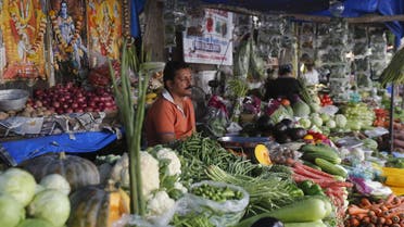 A vegetable vendor waits for customers at his stall in a market in Mumbai, India, December 14, 2015 | Reuters