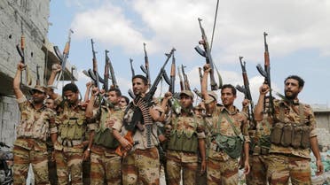 Soldiers loyal to Yemen's government raise their weapons following a training exercise in the country's southwestern city of Taiz. (File photo: Reuters)