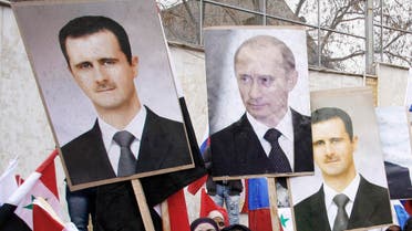 Syrians hold photos of Syrian President Bashar Assad and Russian Prime Minister Vladimir Putin during a pro-Syrian regime protest in front of the Russian embassy in Damascus, Syria, Sunday, March 4, 2012. (AP)
