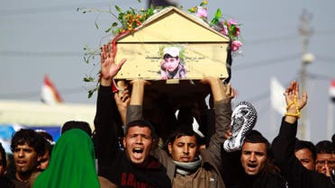  Iraqi mourners carry the body of one of the soldiers who were killed the previous day in a so-called friendly fire from a US-led coalition aircraft west of Baghdad, on December 19, 2015 during a funeral in the Shiite holy city of Najaf. (AFP)