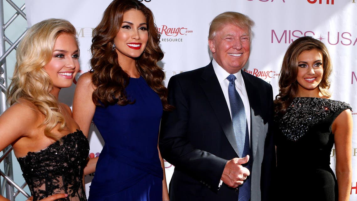 Miss Teen USA 2013 Cassidy Wolf, Miss Universe 2013 Gabriela Isler, Donald Trump, and Miss USA 2013 Erin Brady pose during a red carpet event before the Miss USA 2014 pageant in Baton Rouge, La., Sunday, June 8, 2014. (AP)