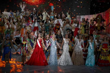 Winner of Miss World 2015 Miss Spain Lalaguna Royo holds hands with other contestants during the pageant in Sanya