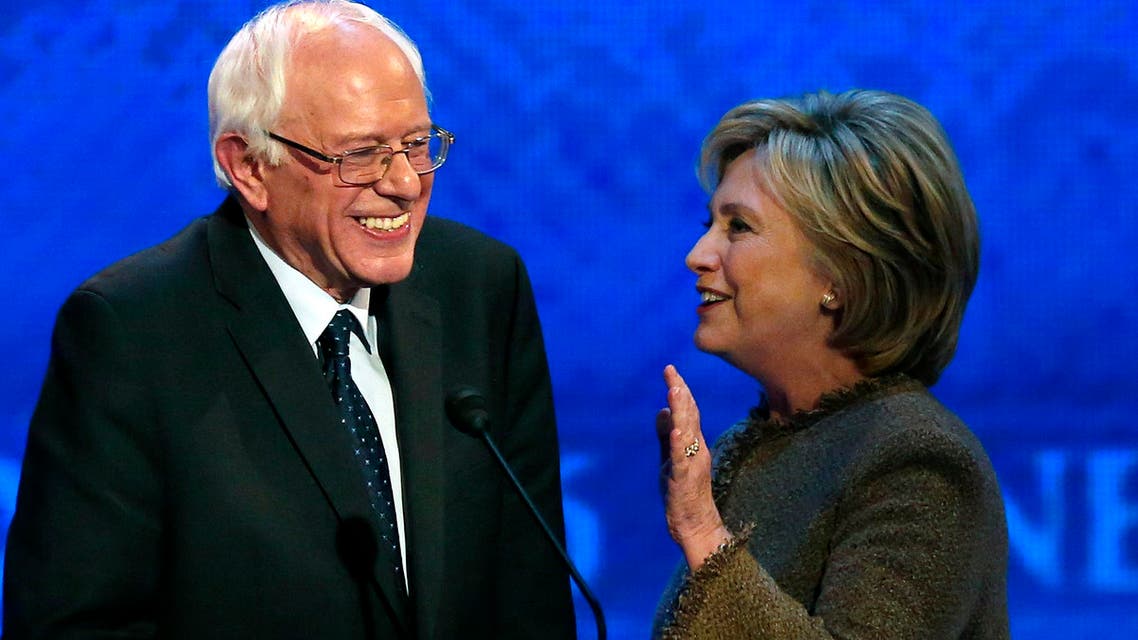 Hillary Clinton, right, speaks to Bernie Sanders during a break at the Democratic presidential primary debate Saturday, Dec. 19, 2015, at Saint Anselm College in Manchester, N.H. (AP)