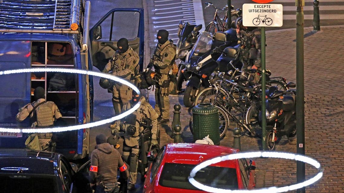 Armed special forces of the police are pictured during searching operations in the Antoine Dansaertstraat - Rue Antoine Dansaert street in the city center of Brussels. (AFP)