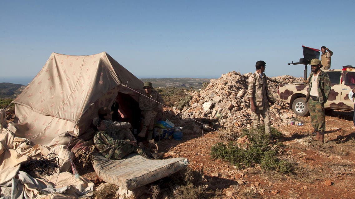 Members of the Libyan pro-government forces, stand near their tent during their deployment in the Lamluda area, southwest of the city of Derna, Libya June 16, 2015. (Reuters)
