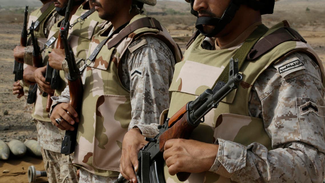 In this photo taken on April 20, 2015, Saudi soldiers with their weapons stand guard at the Yemen border in Jizan, Saudi Arabia. AP
