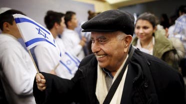 A Jewish immigrant from France arrives for a candle-lighting ceremony to mark the Jewish holiday of Hanukkah, upon landing at Ben Gurion International Airport near Tel Aviv, Israel December 8, 2015 | Reuters