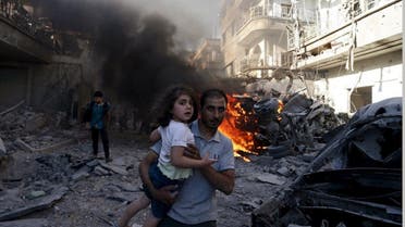 A man carries a girl as they rush away from a site hit by what activists said were airstrikes by forces loyal to Syria's President Bashar al-Assad in the Douma neighbourhood of Damascus, Syria August 24, 2015