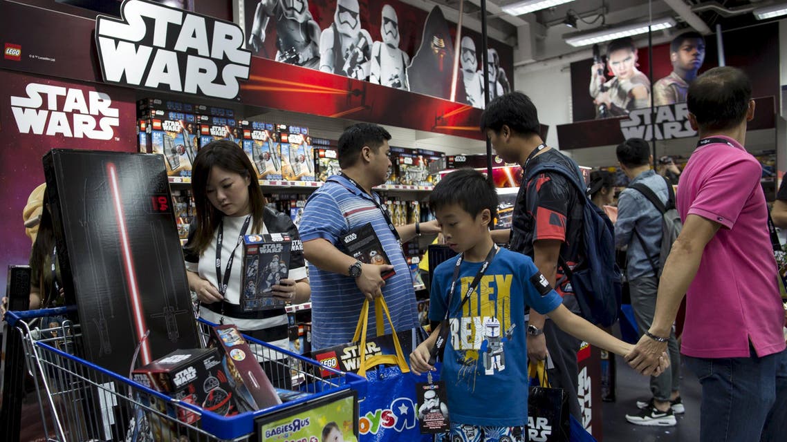 Customers pick new toys from the upcoming film "Star Wars: The Force Awakens" on "Force Friday" in Hong Kong, China, in this September 4, 2015 file photo.