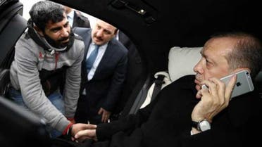 Turkish President Recep Tayyip Erdogan shakes hands with a man who was about to allegedly attempt suicide off the Bosporus bridge in Istanbul, on December 25, 2015. (Agence France-Presse photo)