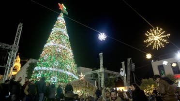  Christian Palestinians attend the lighting of a Christmas tree in Manger Square, outside the Church of the Nativity in the West Bank town of Bethlehem, Saturday, Dec. 5, 2015. Christmas Eve is a major event for the biblical town, but Mayor Vera Baboun said the city would only decorate Manger Square this year. The holiday spirit will be harder to find after weeks of Israeli-Palestinian violence. (AP Photo/Majdi Mohammed)