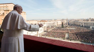 Pope Francis delivers his "Urbi et Orbi" (to the city and to the world) blessing from the central balcony of St. Peter's Basilica at the Vatican, Friday, Dec. 25, 2015.