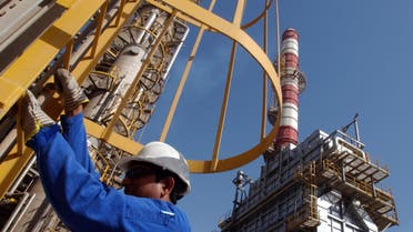 An oil technician climbs down a tower at a refinery in Jebel Ali about 30 kms south of Dubai in United Arab Emirates in this file photo taken in March 2004. ap