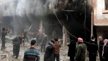 This photo released on Sunday, Dec 13, 2015 by the Douma Revolution News Network on their Facebook page, shows Syrians trying to extinguish fire that was caused by Syrian government aerial bombardment on the Damascus suburb of Douma, Syria. ap