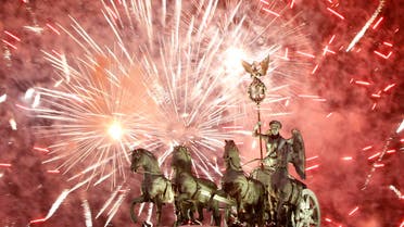 Fireworks illuminate the Quadriga sculpture atop the Brandenburg Gate during a New Year's Eve party in Berlin, January 1, 2011. (Reuters)