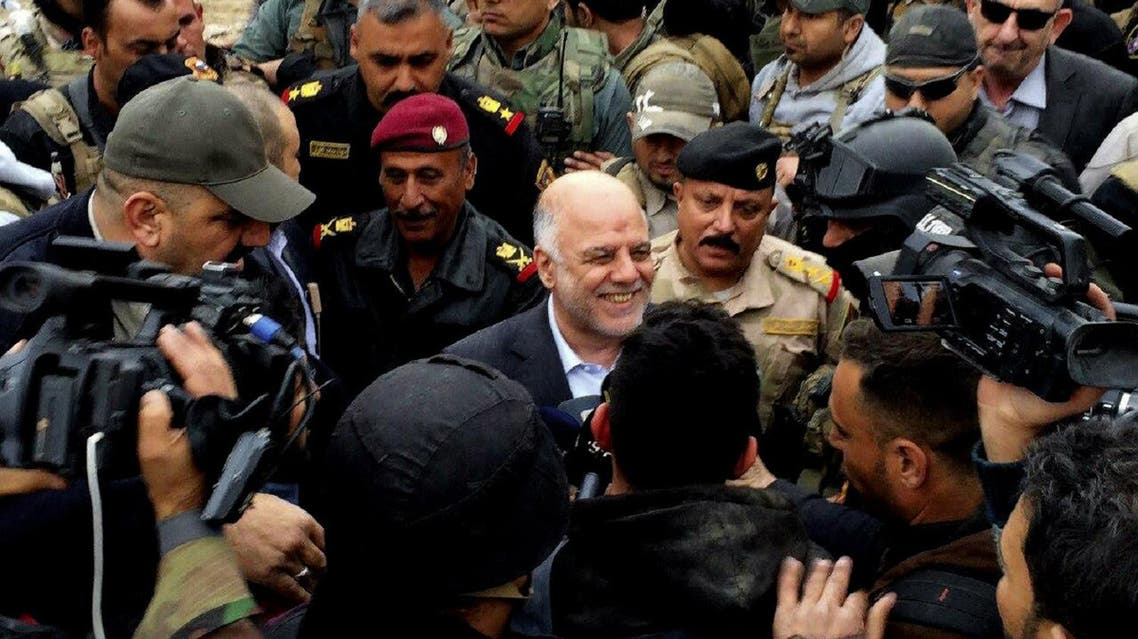Iraqi Prime Minister Haider al-Abadi, center, smiles as he tours the city of Ramadi after it was retaken by the security forces in Ramadi. (AP)