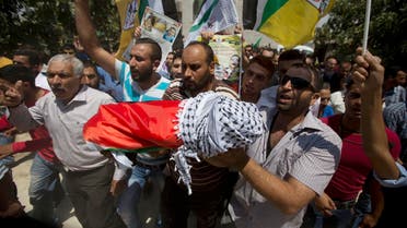 Palestinians carry the body of one-and-a-half year old boy, Ali Dawabsheh, during his funeral in Duma village near the West Bank city of Nablus. (File photo: AP)