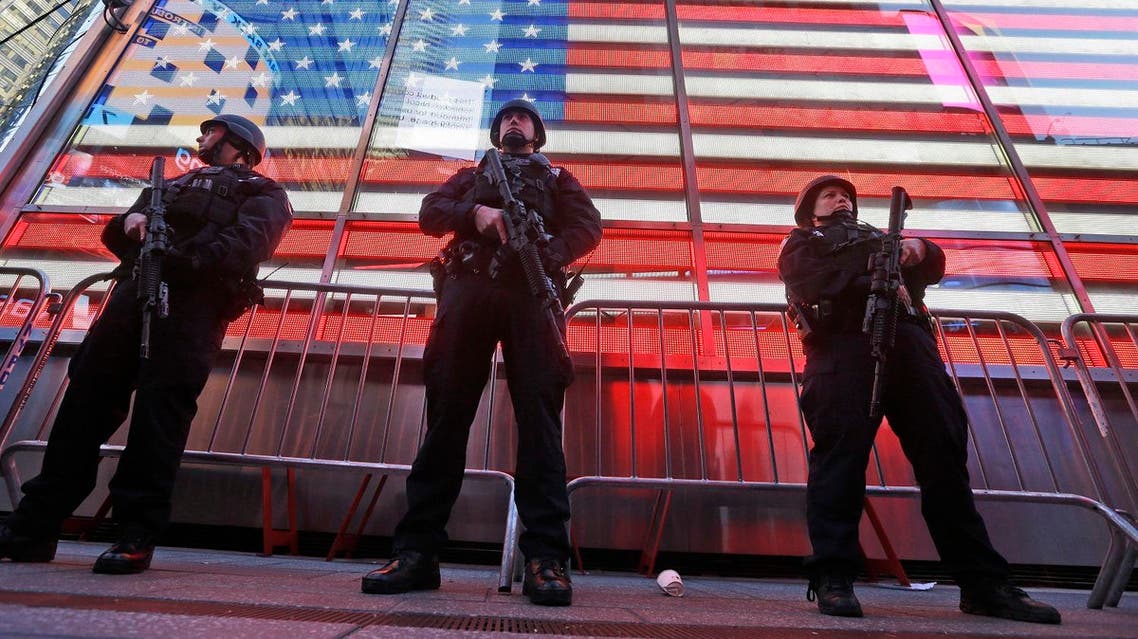 In this Nov. 14, 2015 file photo, heavily armed New York city police officers with the Strategic Response Group stand guard at the armed forces recruiting center in New York's Times Square. (AP)
