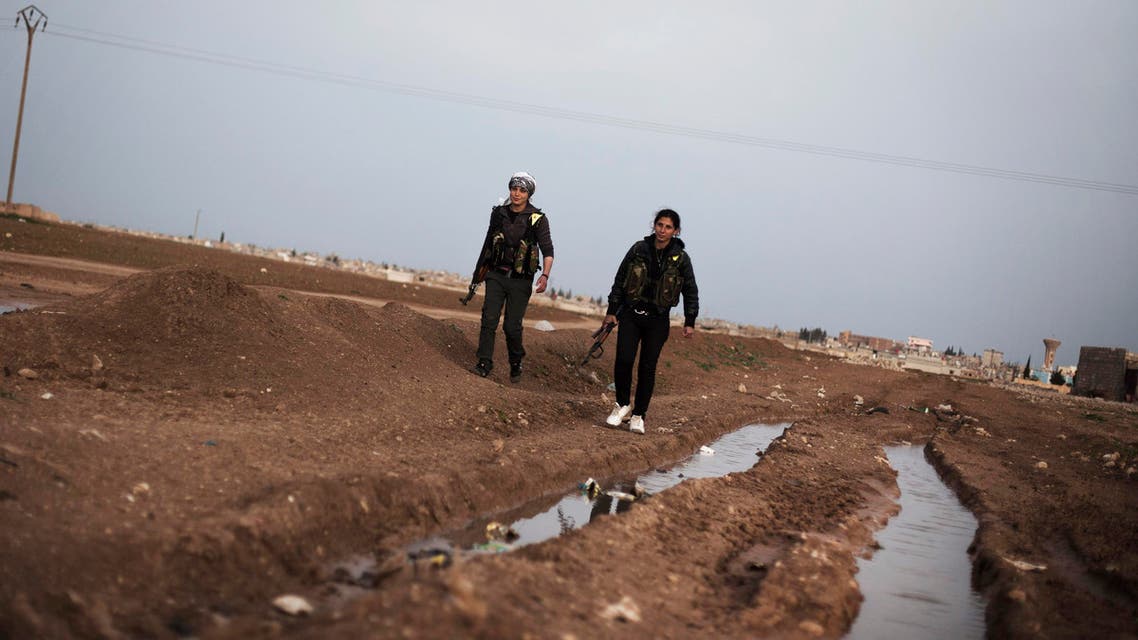 Kurdish female members of the Popular Protection Units gurad a check point near the northeastern city of Qamishli, Syria, Sunday, March 3, 2013. (AP)