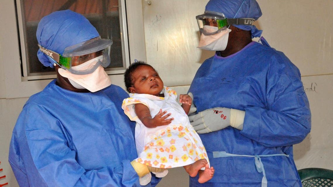 medical workers presenting Noubia (C), the last known patient to contract Ebola in Guinea, during her release from a Doctors Without Borders treatment center in Conakry. (File photo: AFP)