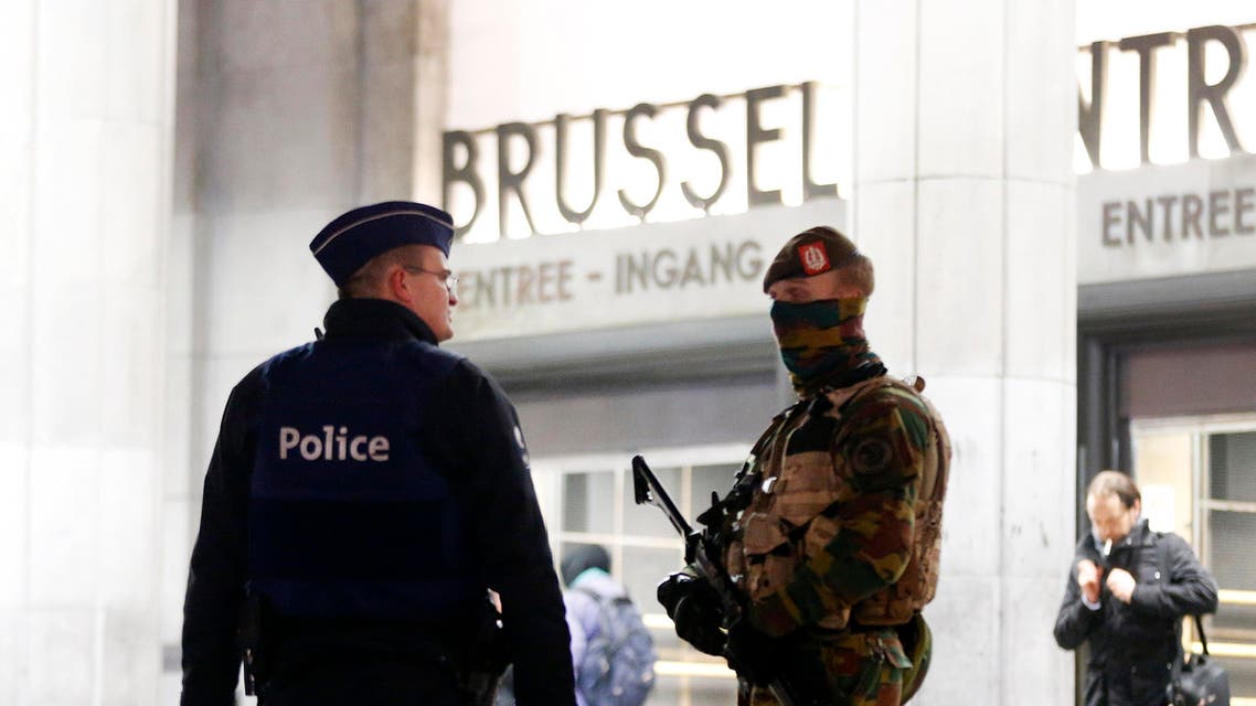 Belgium police officers talk to each other in front of the central station in downtown Brussels, Belgium, Monday, Nov. 23, 2015. The Belgian capital Brussels has entered its third day of lockdown, with schools and underground transport shut and more than 1,000 security personnel deployed across the country. (AP Photo/Michael Probst)