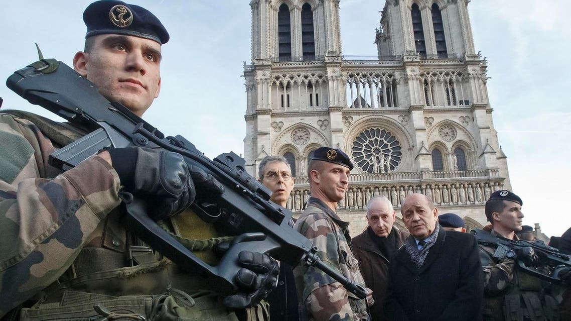 France's Defense Minister Jean-Yves Le Drian, 2nd right, talks to soldiers at the Notre Dame cathedral in Paris. (AP)