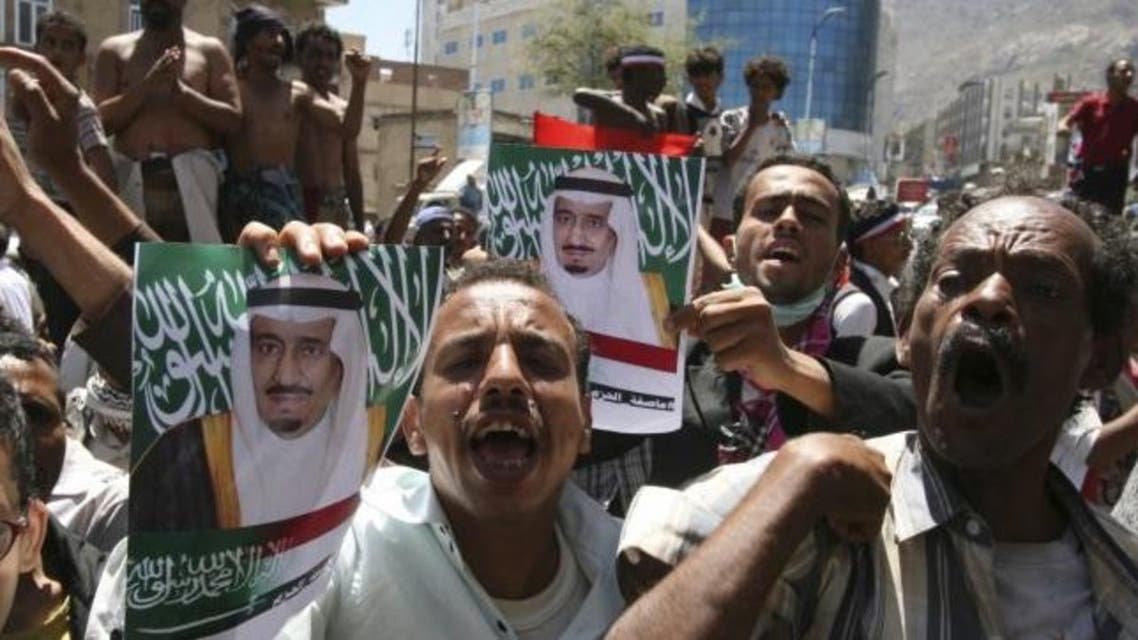 Anti-Houthi protesters hold posters of Saudi King Salman to show their support for Saudi-led airstrikes in Yemen (Reuters)