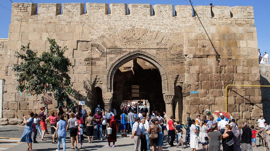 A file picture taken on September 19, 2015 shows people walking in front of the Naryn-Kala Fortress in Derbent. (AFP)