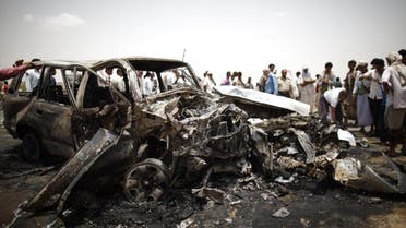 Policemen and people check the scene of a collision on a highway leading to a border crossing between Yemen and Saudi Arabia May 18, 2013. (Reuters)