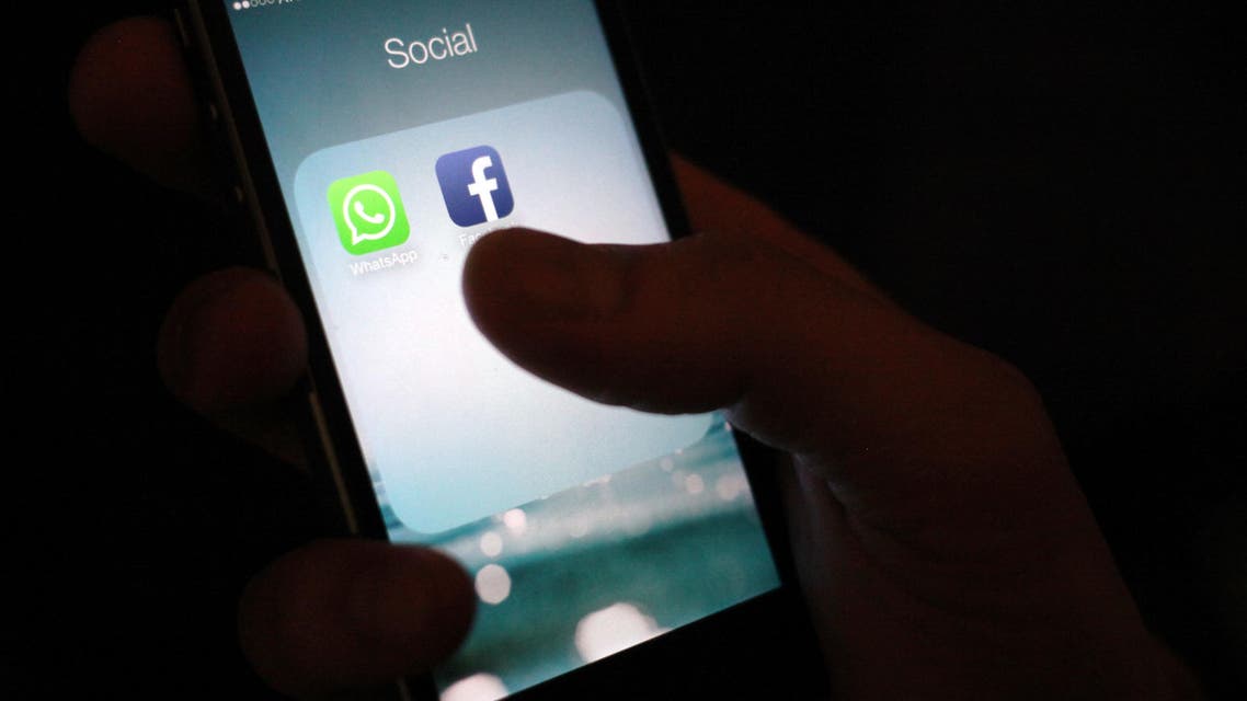This Wednesday, Feb. 19, 2014 photo, shows the WhatsApp and Facebook app icons on an iPhone in New York. On Wednesday Facebook announced it is buying mobile messaging service WhatsApp for up to $19 billion in cash and stock. (AP