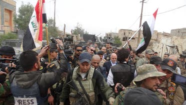 Iraqi Prime Minister Haider al-Abadi walks with his security detail in the city of Ramadi, December 29, 2015. (Reuters)