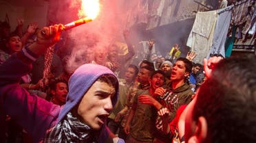 In this Friday, April 24, 2015 file photo, an Egyptian youth carries a lit flare as supporters of the Muslim Brotherhood gather in the El-Mataria neighborhood of Cairo, Egypt, to protest the 20-year sentence for ousted president Mohammed Morsi and verdicts against other prominent figures of the Brotherhood. (AP Photo/Belal Darder, File)