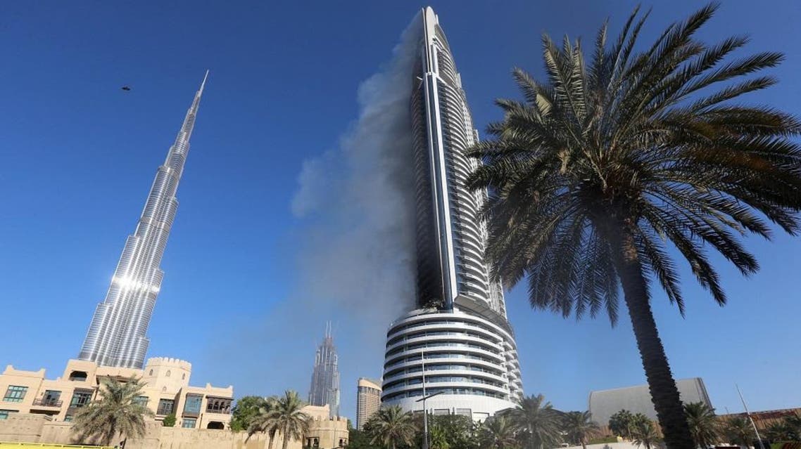 Plumes of smoke rise from the 63-storey Address Downtown Dubai hotel and residential block near the Burj Khalifa, the tallest building in the world, a day after the hotel caught fire on New Year's Eve, in Dubai January 1, 2016 | Reuters