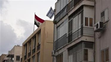  The Egyptian flag on the roof of the Egypt embassy in Tel Aviv, next to an Israeli flag from a nearby resident's balcony, August 20, 2011. 