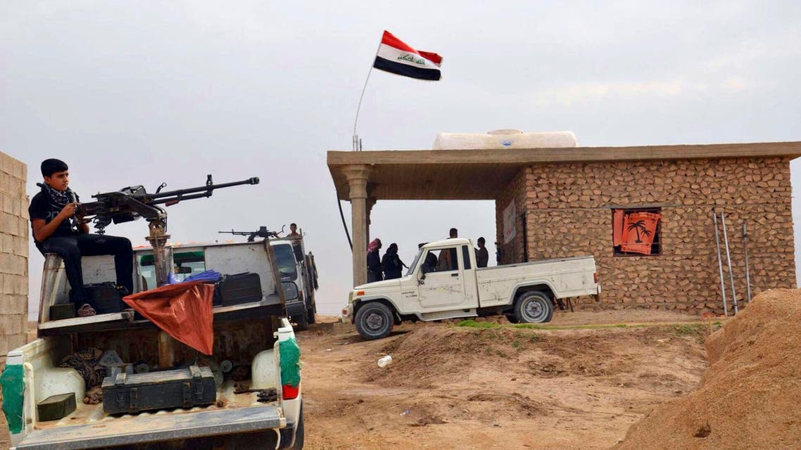 In this Friday, Oct. 17, 2014 photo, Iraqi security forces and tribal fighters gather to defend the city of Haditha 240 kilometers (150 miles) northwest of Baghdad, Iraq. Iraq is facing its worst crisis since the 2011 withdrawal of U.S. troops, with the Islamic State extremist group in control of about a third of the country. (AP Photo)