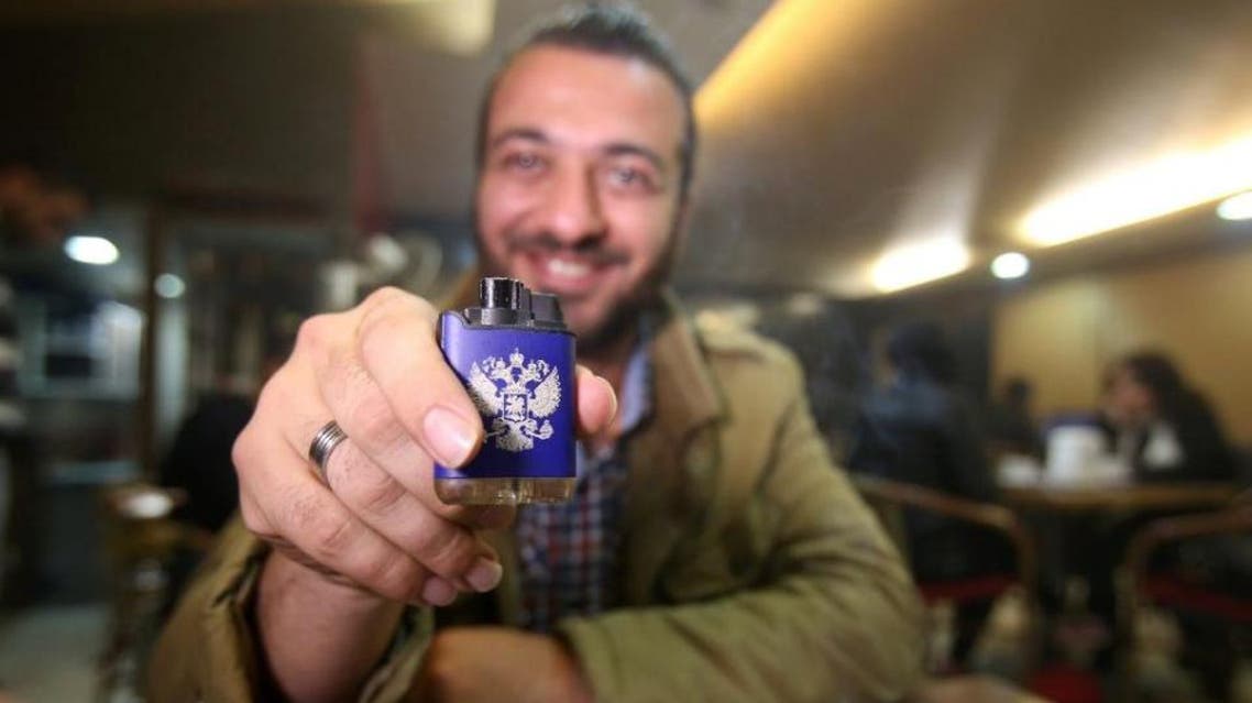 In the windows of his father's shop in coastal Syria, Ihab replaces bottles of the national tipple arak with vodka
