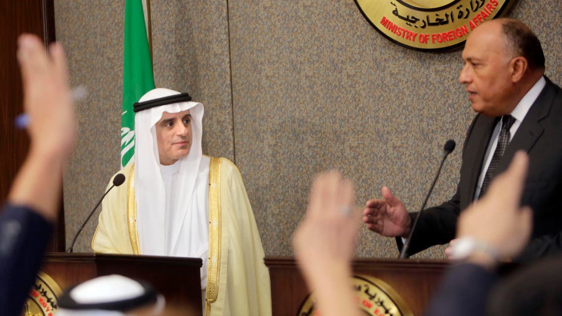 Reporters raise their hands during a press conference for Egyptian Foreign Minister, Sameh Shoukry, right, and his Saudi counterpart Adel al-Jubair, at the foreign ministry headquarters in Cairo, Egypt, Sunday, Oct. 25, 2015. AP