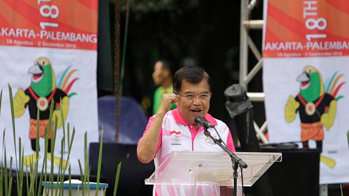 In this Dec. 27, 2015 photo, Indonesian Vice President Jusuf Kalla delivers his speech as banners with Asian Games mascot, called Drawa, stand in the background in Jakarta, Indonesia. Indonesia is revising the mascot for the 2018 Asian Games after the newly unveiled bird-of-paradise is derided by netizens. Gatot Dewa Broto, a senior official at the Ministry of Youth and Sport said Tuesday, Jan. 5, 2016, the revision of the mascot is expected to be finalized within between two and four months. (AP Photo)