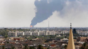A file photo shows black smoke over the skyline of Tripoli, Libya as a fire at an oil depot rages out of control after being struck in the crossfire of warring militias. (AP) 