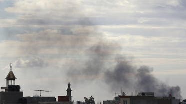 Black smoke billows in the sky above areas where clashes are taking place between pro